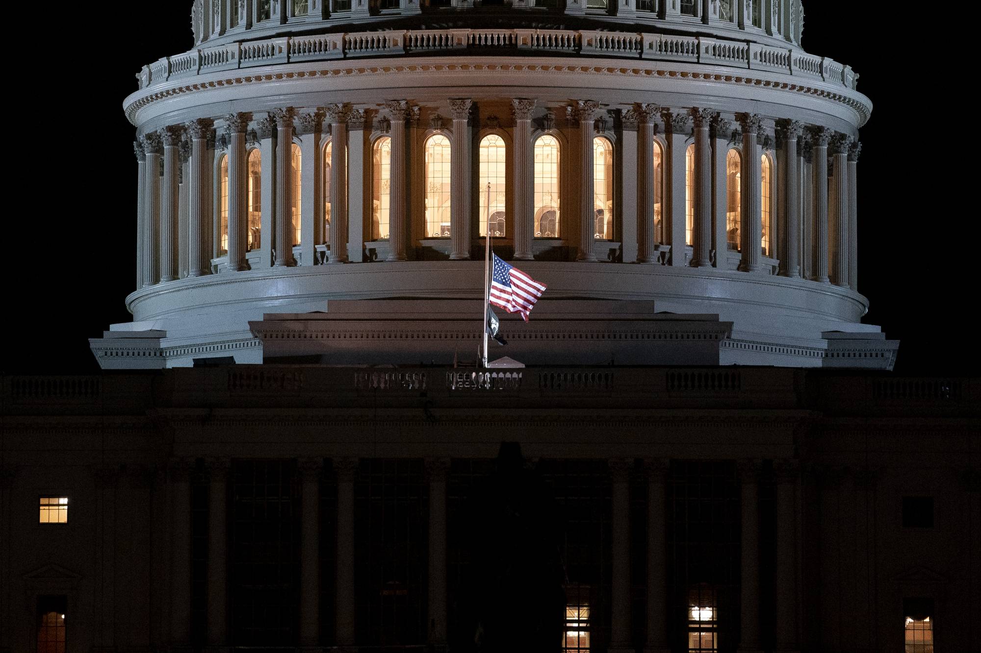 The American flag flies at half staff at the U.S. Capitol in Washington, D.C., U.S., on Friday, Jan. 8, 2021. House Democrats are prepared to impeach President Donald Trump if he doesn’t immediately resign, House Speaker Nancy Pelosi said, as the president came under increasing pressure from members of both parties for encouraging a mob that stormed the U.S. Capitol. Photographer: Stefani Reynolds/Bloomberg