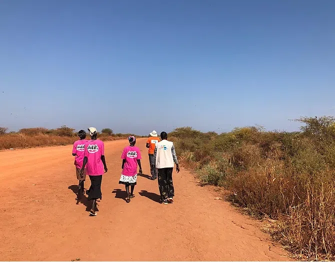 Three NP protectors and civilians on road