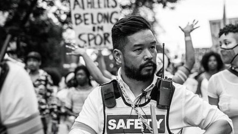 Crowd marching with sign 