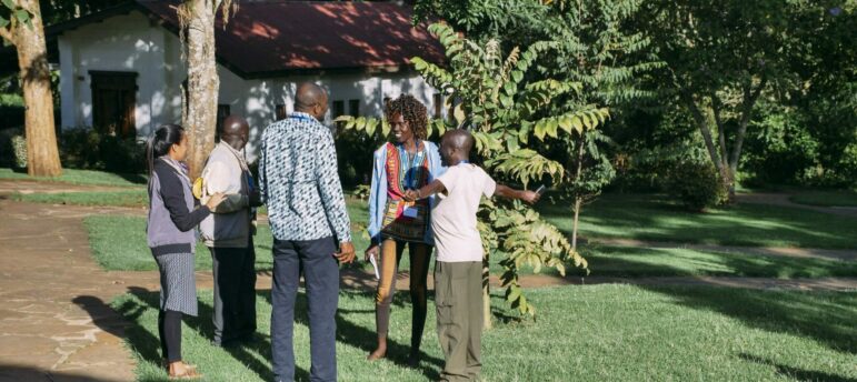 Several people standing near each other in an outdoor setting.