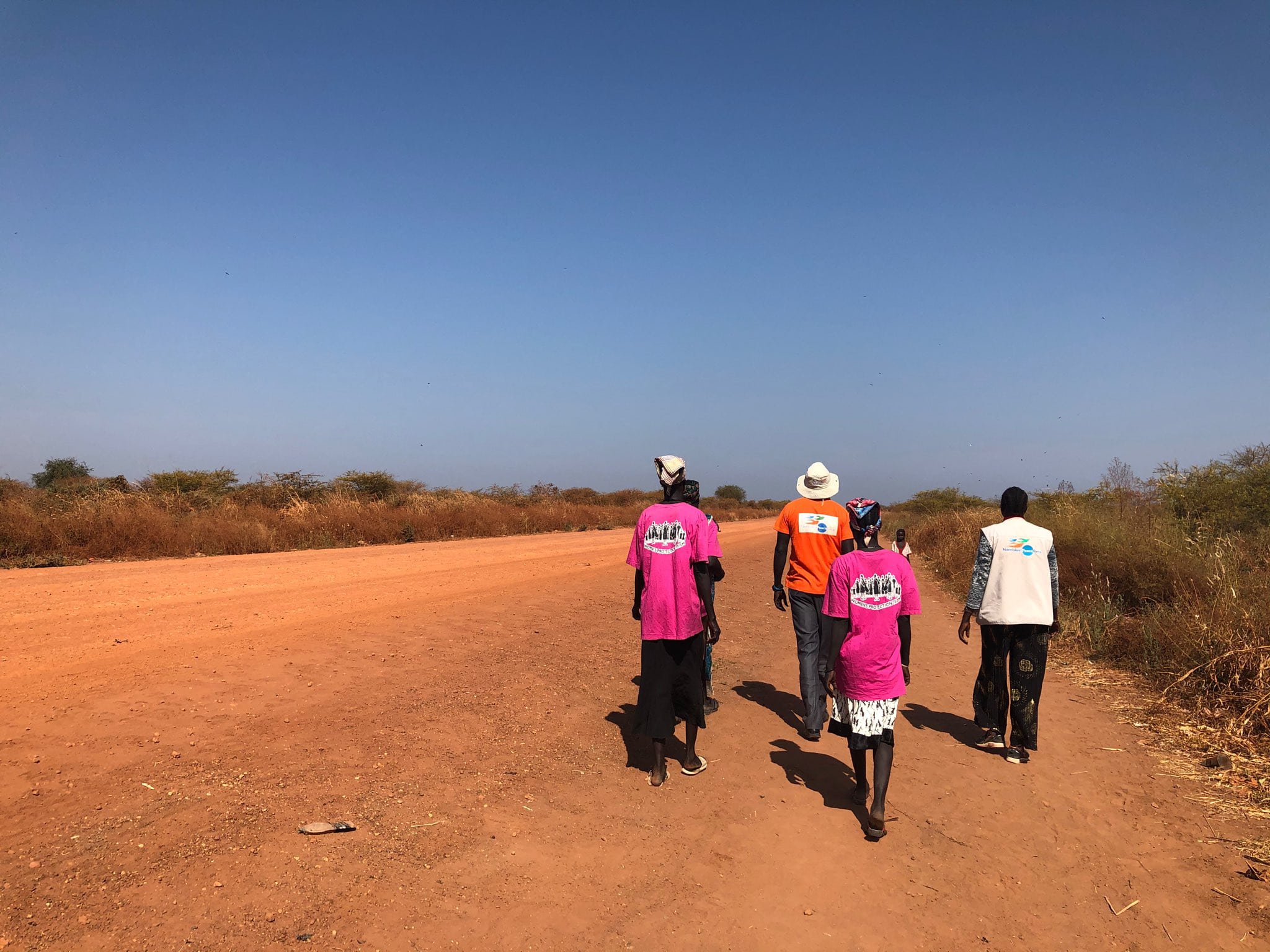 Three NP protectors and civilians on road