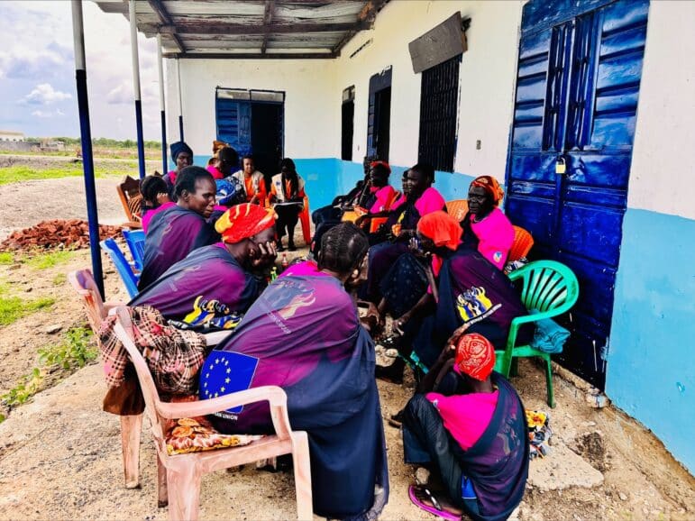 Members of the Women Civic Action Group (WCAG) are sitting together in lawn chairs outdoors as they speak with Nonviolent Peaceforce and Solidarites International staff. Location is Pariak, a village in Upper Nile of Melut County, South Sudan.