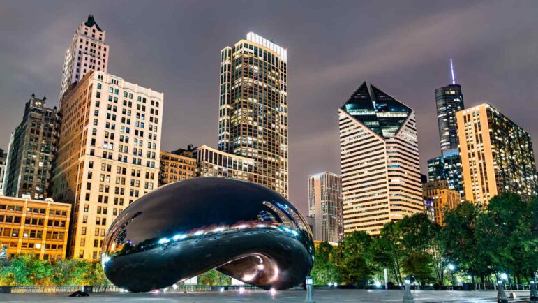 Bean sculpture in the Chicago skyline at night