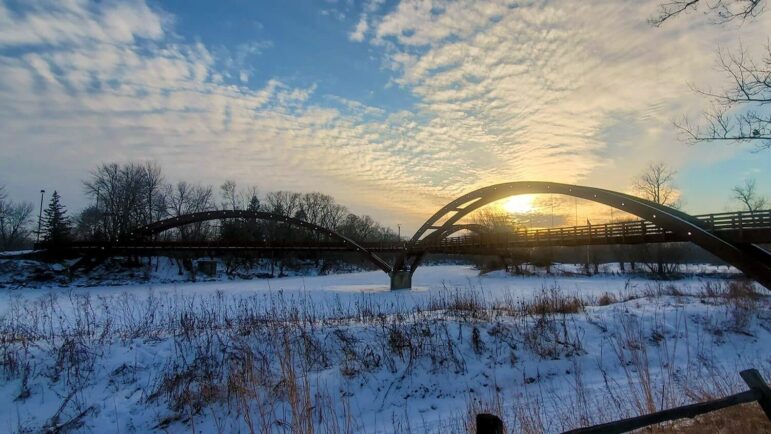 Midland Michican scene -- it is snowy with a bridge by sunrise or sunset