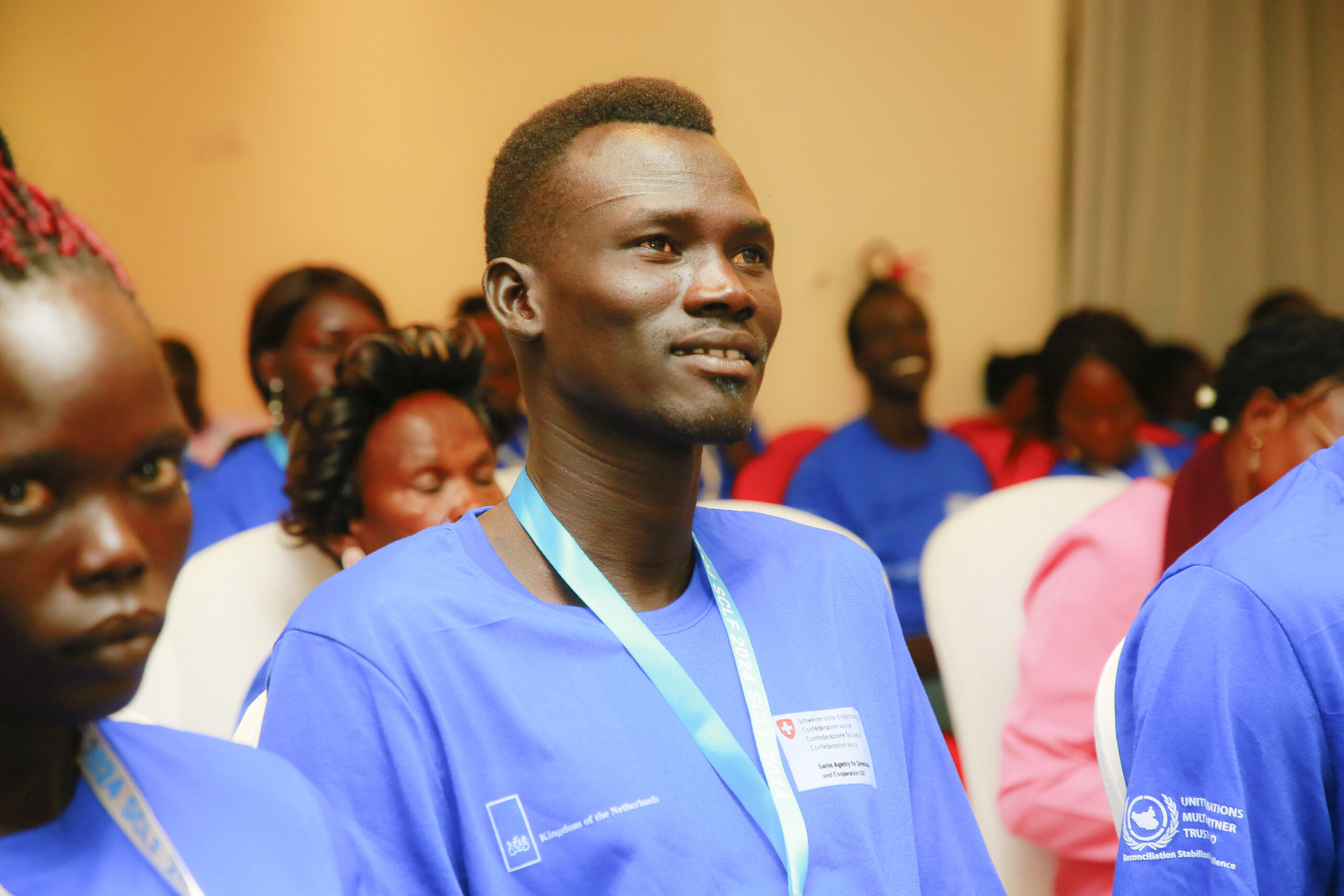 Attendee smiles while they listen to the speaker at the Stakeholder Collaboration and Learning Forum 2024.