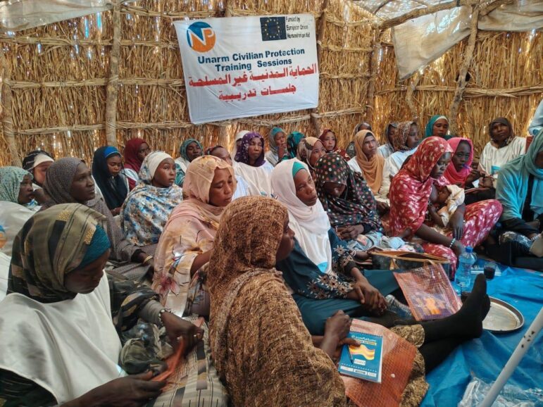 Women Protection Team (WPT) leaders sitting down inside a shelter during a training on Unarmed Civilian Protection (UCP).