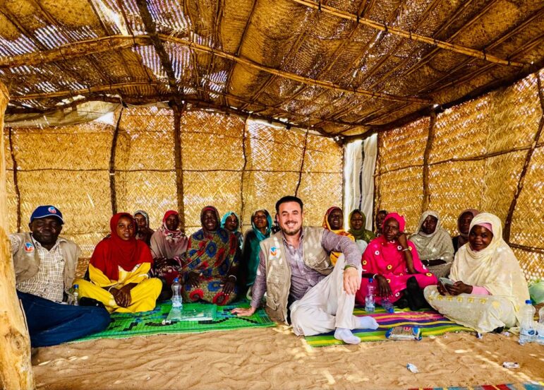Women and two NP staff members sitting with a group of women following providing a training on Unarmed Civilian Protection in Tawila, Sudan.