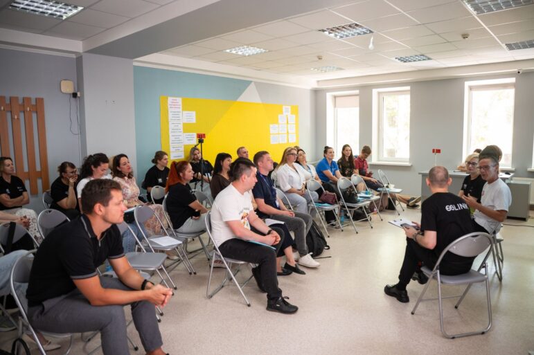 Participants of the expert discussion sitting in chairs.