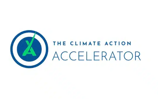 Logo for the Climate Action Accelerator. It features a blue circle with a green A and a green checkmark inside, alongside the text The Climate Action Accelerator in blue.