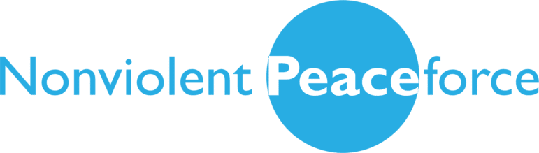 Text logo with the words Nonviolent Peaceforce. Peace is bolded in white within a large blue circle, while the rest of the text is in light blue on a white background.