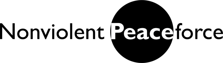 The word Nonviolent Peaceforce in black text, with Peace in white letters inside a large black circle, and the rest of the text outside the circle on a light background.